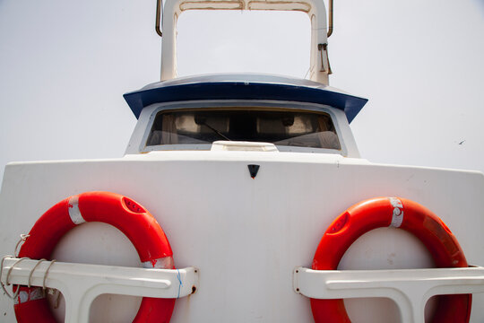 Red lifebuoys mounted on the front of a working fishing boat