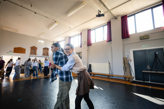Promenade embrace mid-rehearsal