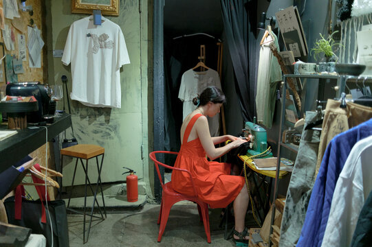 Fashion designer working with fabric in her studio