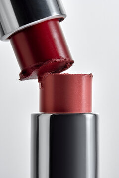 Two Lipsticks Colliding With Realistic Imperfect Texture And Gloss