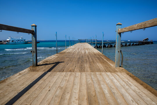 Scenic view of broken and collapsed wooden pier by turquoise sea