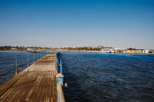 Scenic view of broken and collapsed wooden pier by turquoise sea