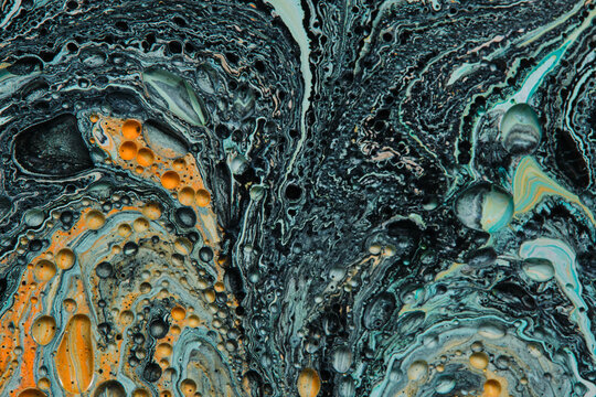Dark abstract fluid painting with swirling dark tones, turquoise accents, and golden dots.
