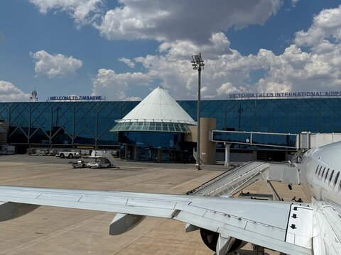 Airplane Wing and Fuselage on Tarmac at Victoria Falls International Airport Terminal in Zimbabwe