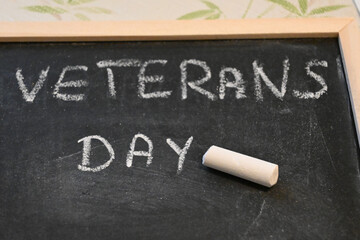 Veterans Day written in white chalk on a blackboard © Veronika