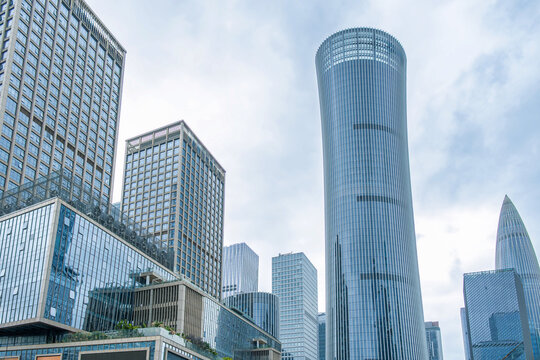 Contemporary glass skyscrapers in modern business district in Shenzhen city, China. Corporate architecture, financial economy, high-rise development, commercial buildings, metropolitan infrastructure