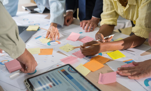 Business hands creating project financial charts and data mind map with colorful sticky notes