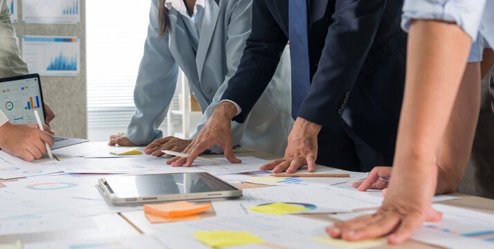 Business hands creating project financial charts and data mind map with colorful sticky notes