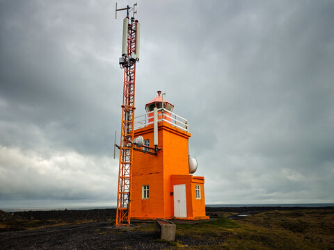 Bright Orange Hopsnes Lighthouse and Cell Tower in Iceland