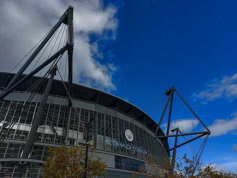 Sports and Architecture: Exterior View of Etihad Stadium Home of Manchester City FC Under Blue Sky in Manchester England