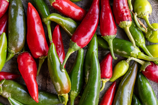 Fresh red and green chili peppers in a vibrant flat lay composition   