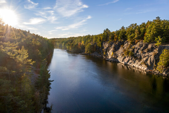 Serene sunset over French River, Ontario, showcasing calm waters and lush forests.