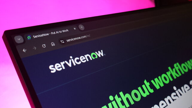 Servicenow home page on laptop screen in dark room with pink lighting highlights modern business management software and automation technology for global companies.