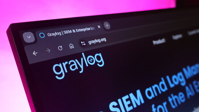 Graylog log management software interface displayed on computer monitor with blue glow representing enterprise security information and event management solutions.