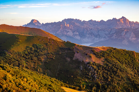 A view of the valleys and mountains of the Picos de Europa, bathed in the colours of dawn, from the Collado de Llesba viewpoint in Cantabria, Spain