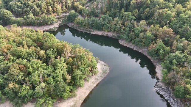 Aerial drone footage of Lake Panneciere surrounded by green hills in Morvan Burgundy