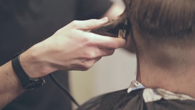 Hair clipper trimming client neck close up. Barber making fade haircut salon.