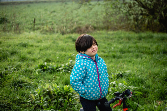 Upset and Crying Child in Puffer Jacket Standing in a Field