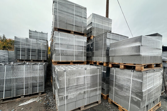 Large outdoor storage of stacked and wrapped concrete block pallets