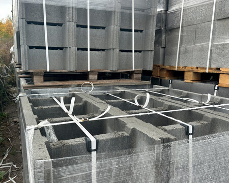 Strapped pallets of concrete hollow blocks in storage