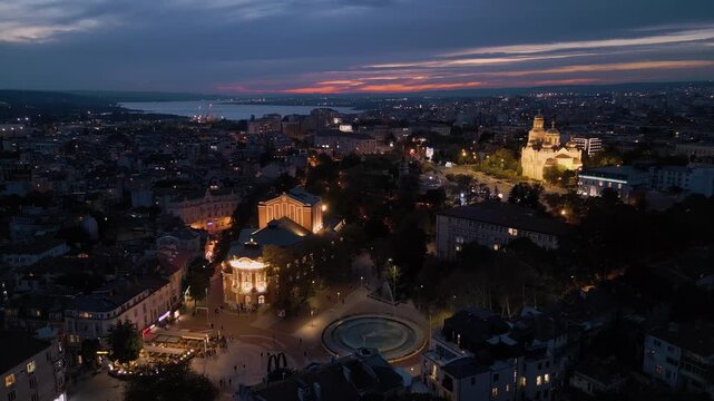 Aerial view of Varna drama theater and cathedral illuminated at dusk, Bulgaria
