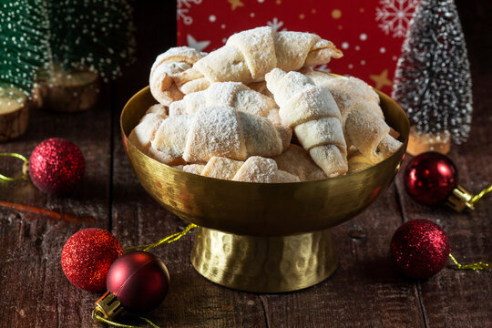 Traditional Jam-Filled Crescent Cookies with Powdered Sugar and Christmas Holiday Decor