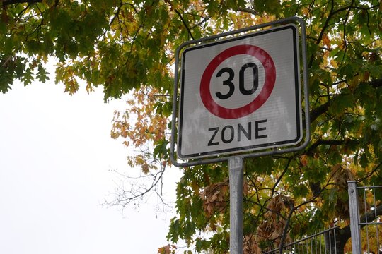 30 km h Speed Limit Zone Sign Surrounded by Autumn Leaves Germany 