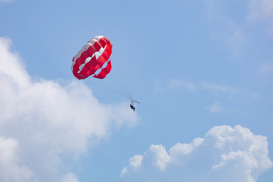Red Parasail Flying in a Blue Summer Sky Over Cancun Beach, Mexico