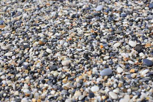 Sea pebble stones texture background close up