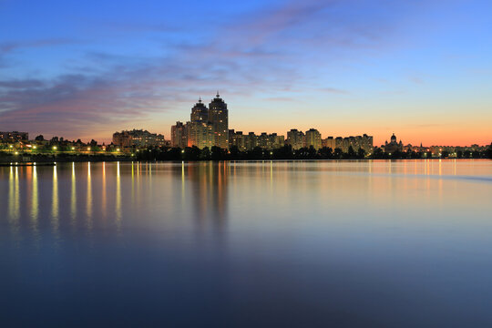 Scenic view of the Obolon residential district and embankment lake during beautiful colorful sunset in Kyiv Ukraine