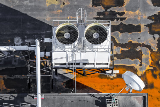 Rooftop cooling tower system with satellite dish
