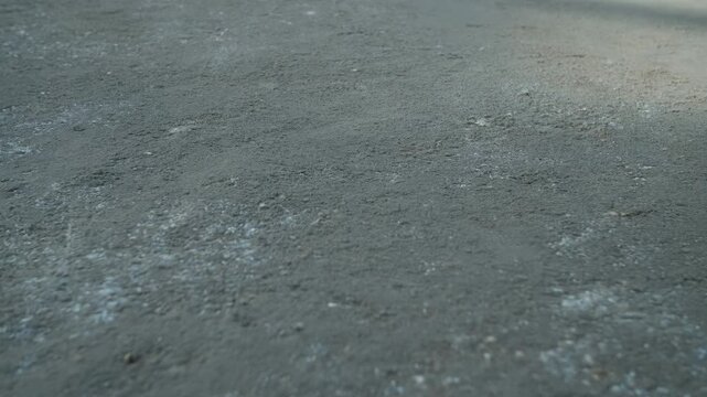 Rough concrete ground surface with slowly shifting soft shadows in natural outdoor light. Texture overlay, architecture presentation, and construction project design.