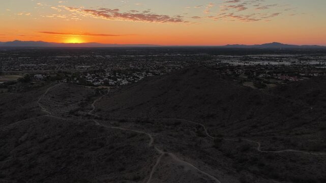 Aerial view of desert hills and Phoenix city sprawl at sunrise