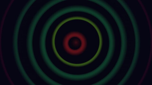 Concentric circles in green and red hues create a looping visual effect on a dark background.