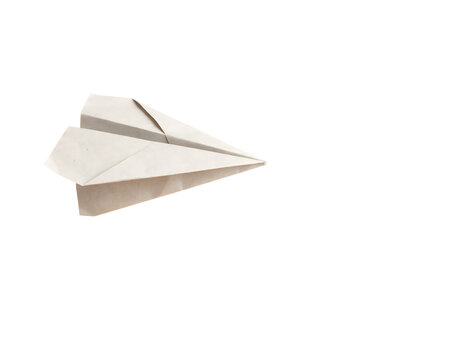 A simple white paper airplane folded from a single sheet of paper, angled view showing the wings and pointed nose against a dark background, isolated on a, transparent background
