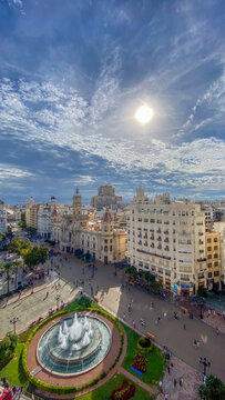 Scenic high angle view of the historic Plaza del Ayuntamiento in Valencia, Spain, featuring the central fountain, historic architecture on  sunny day under a bright sky.