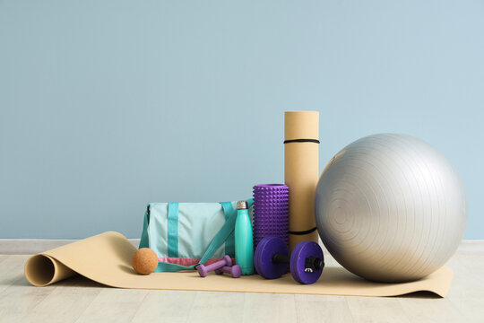 Fitness and wellness routine, home workout equipment with yoga mat, exercise ball, foam roller and dumbbells for healthy lifestyle and active living