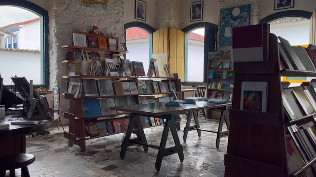Interior of cozy empty bookstore with wooden bookshelves and books, static view, Paraty, Rio de Janeiro, Brazil