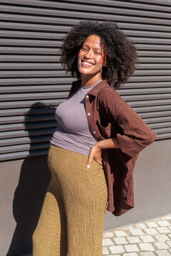 Pregnancy and motherhood, happy pregnant woman smiling outdoors