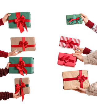 Female hands with Christmas gifts on white background