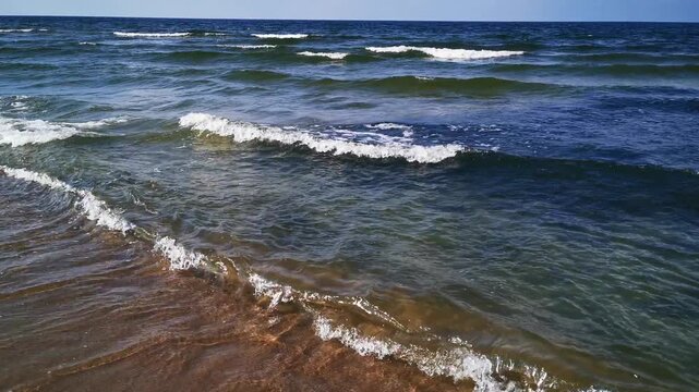 Foamy Waves Wash across Shallow Coastal Water