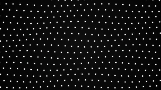 White dots form a geometric grid pattern on a black background in a seamless loop.