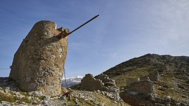 Spring in Crete, plateau, mountain ridge, pass, Ambelos, windmill, ruins, wide angle, blue sky, veil clouds, snow-capped mountains, Lassithi, East Crete, island of Crete, Greece
