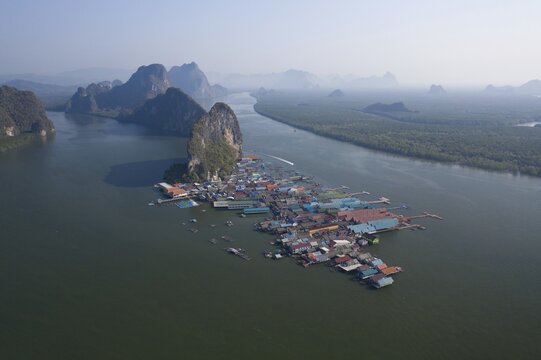 Aerial view, wooden house settlement, pile dwelling village with high karst rocks in the background, Ao Phang-Nga National Park, Phang-Nga Province, Thailand