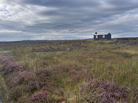 Lonely hut in a vast moorland landscape with cloudy sky, Isle of Lewis Hebrides, Scotland, Great Britain