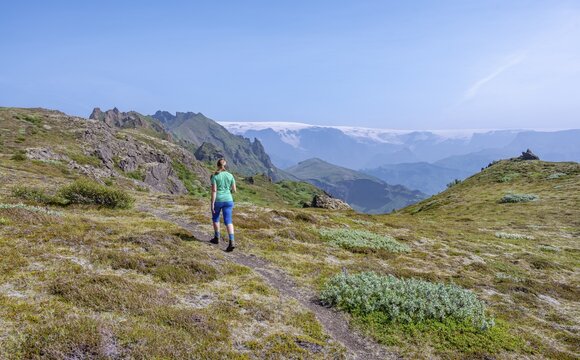 Hiker on trail, mountains, wild nature, M&yacute;rdalsj&ouml;kull glacier behind, Icelandic Highlands, &THORN;&oacute;rsm&ouml;rk, Su&eth;urland, Iceland