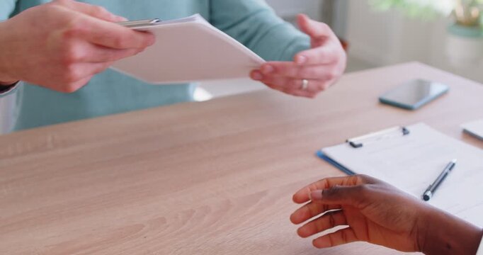 Man job seeker giving his cv resume to female african american HR manager sitting at the desk in office at meeting. Recruitment, human resources and employee recruit concept. 4k video. Slow motion.