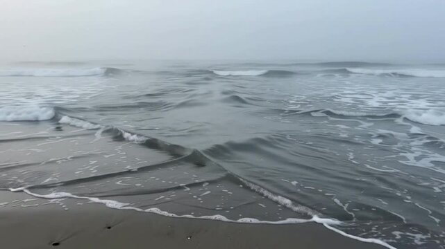 Dangerous rip current flowing through ocean waves at a sandy tropical