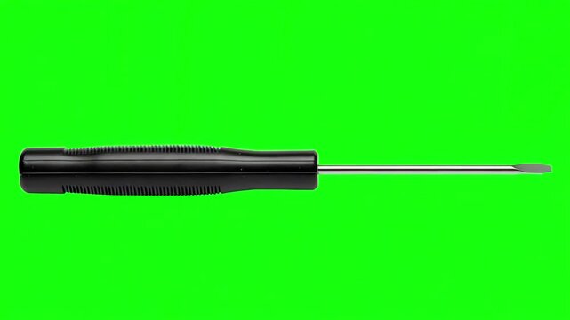 Slim flat head terminal screwdriver sliding horizontally into a green screen studio background for video editing projects