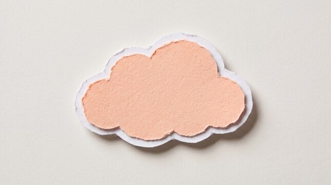 Peach colored cloud shape made from torn paper texture with white edges layered over a light beige background for creative design projects
